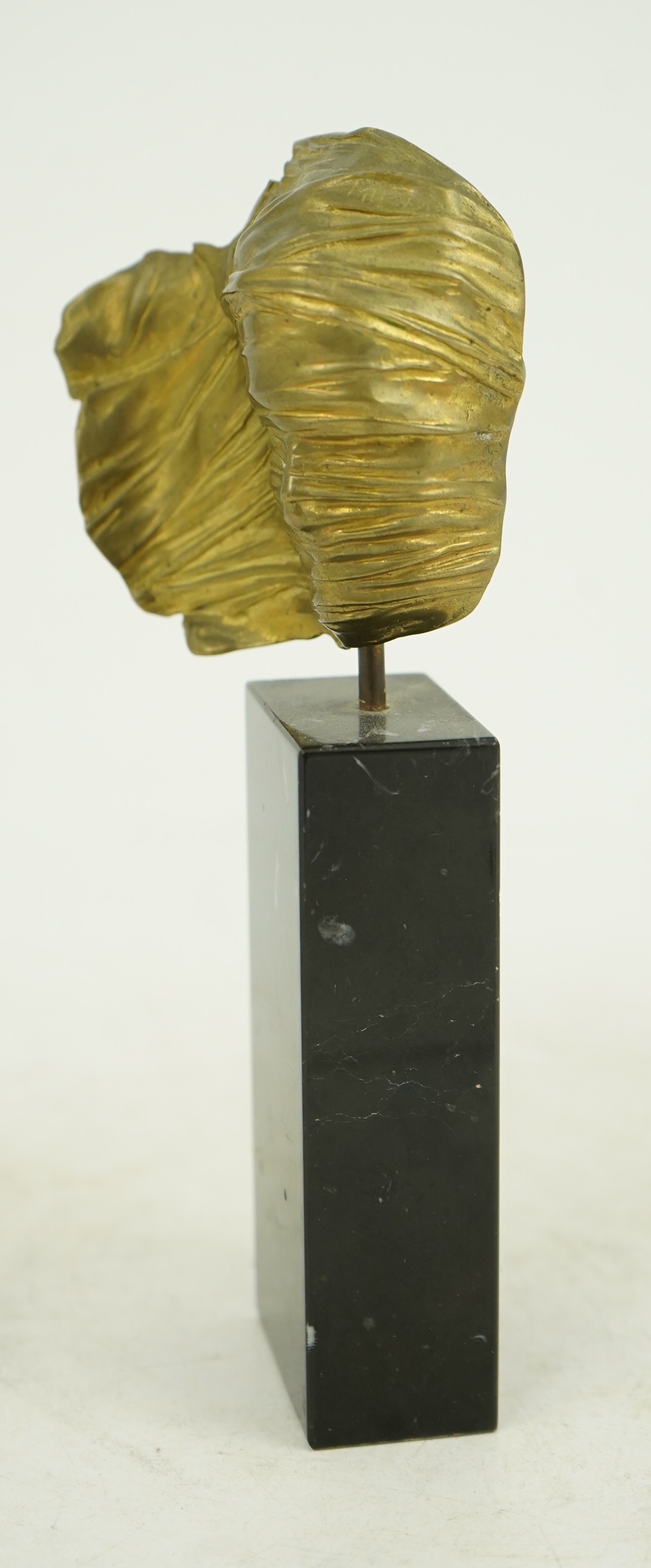 Igor Mitoraj (Polish, 1944-2014), Visage Envolé, bronze and black marble, 16.5 x 7 x 2.5cm